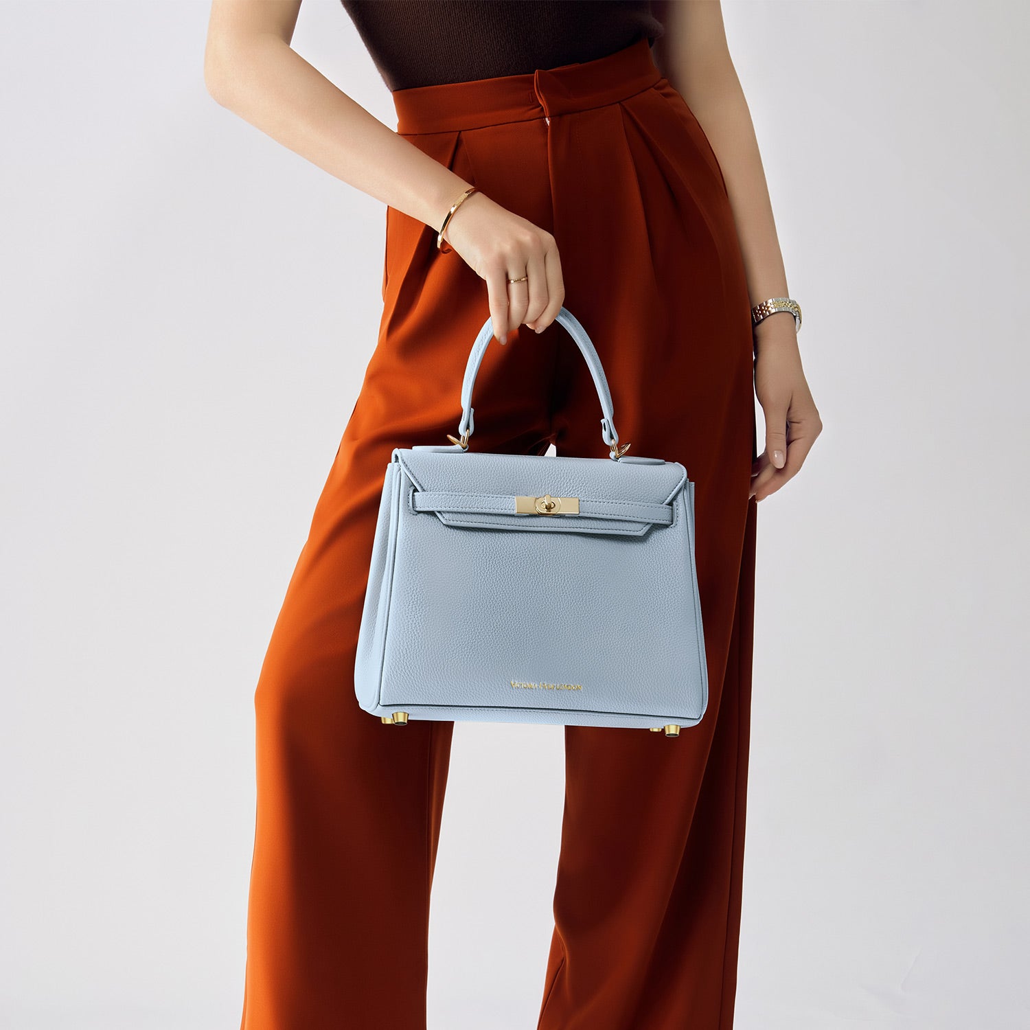 Elegant ash-blue Victoria Hyde handbag: vegan PU leather, light gold details, 3-in-1 carry style. Spacious interior with organized pockets. Lightweight &amp; regal.