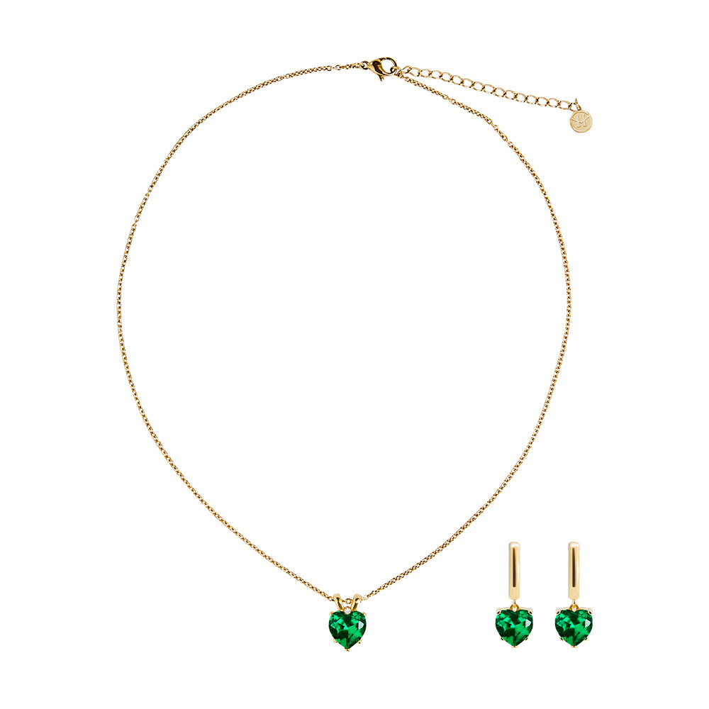 Victoria Hyde London heart-shaped jewelry set: necklace and earrings, light gold with deep green stones. Elegant, luxurious accessory for a refined look.