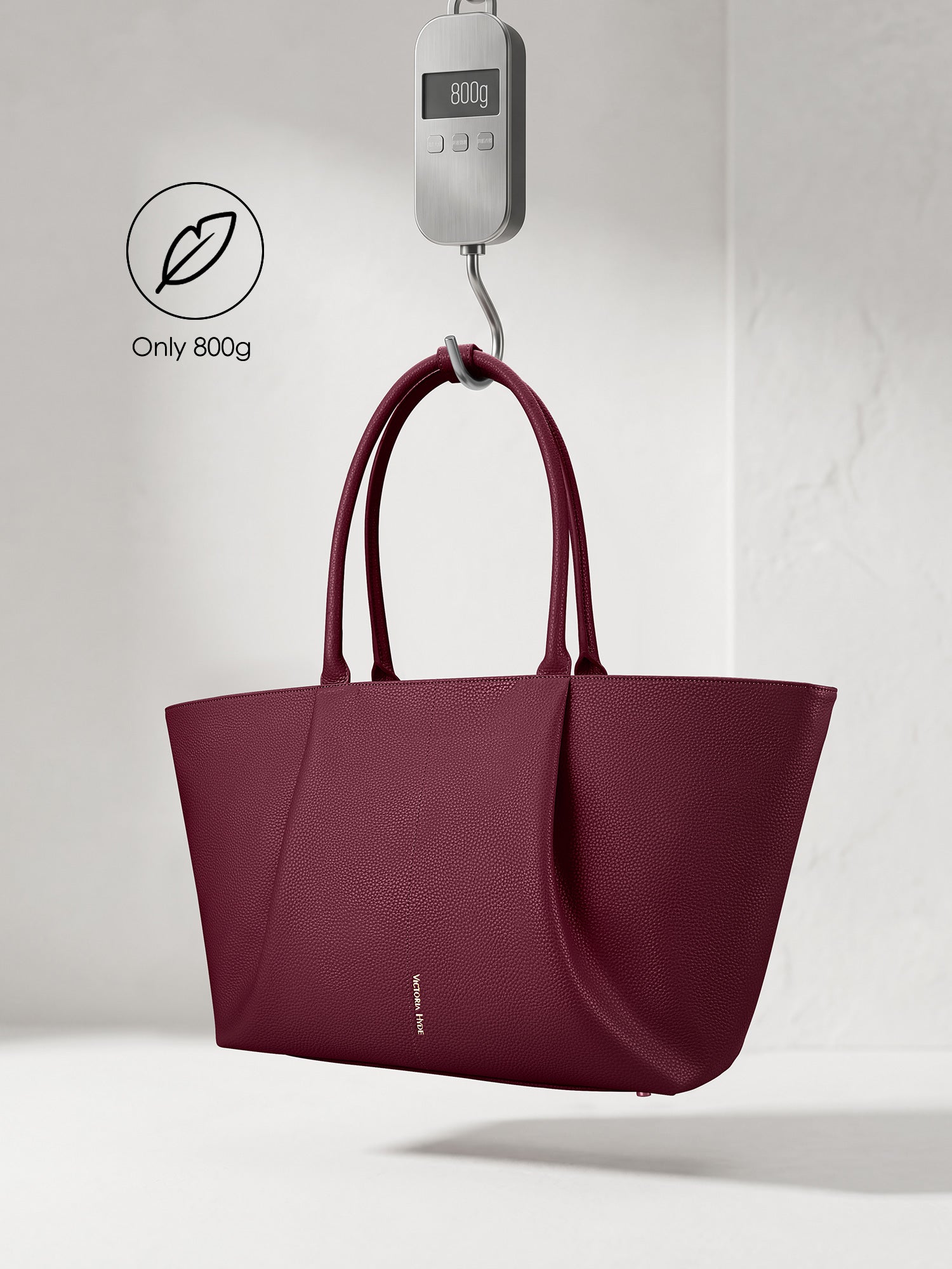 Victoria Hyde Jolene orange laptop bag showing lightweight design, weighing only 800g, stylish vegan leather business bag for 16-inch laptops.