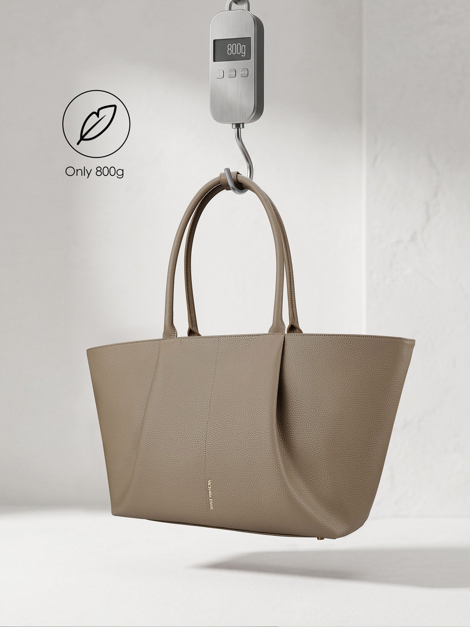 Victoria Hyde Ada beige laptop bag showing lightweight design, weighing only 800g, stylish vegan leather business bag for 16-inch laptops.