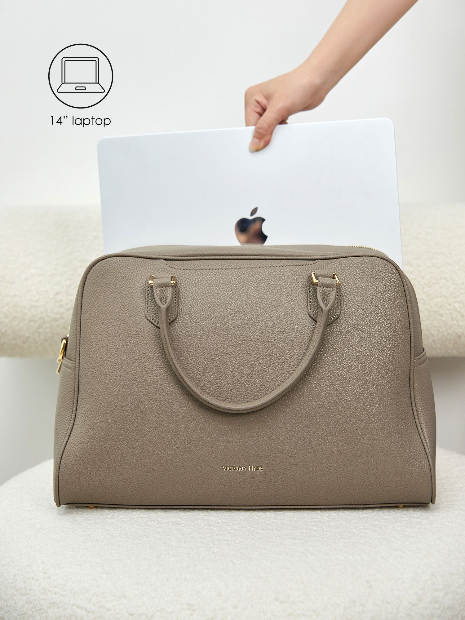 Victoria Hyde Amal beige laptop bag perfectly fitting a 14-inch laptop, demonstrating secure and easy access for professional daily commutes.