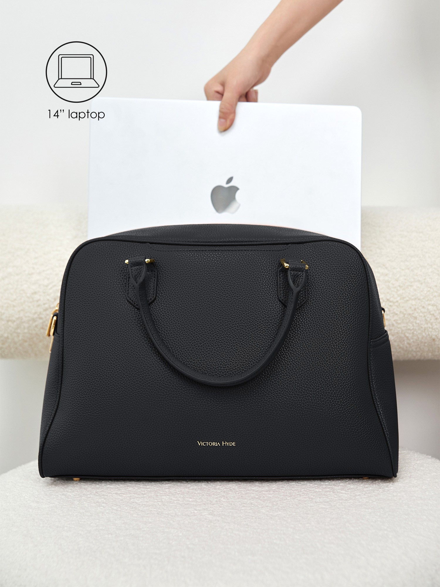 Victoria Hyde Amal black laptop bag perfectly fitting a 14-inch laptop, demonstrating secure and easy access for professional daily commutes.