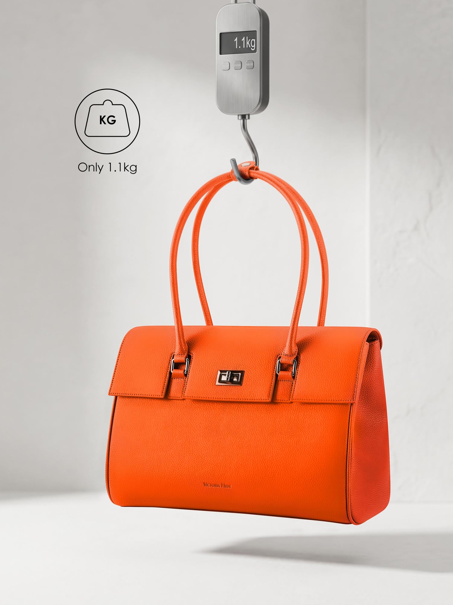 Victoria Hyde Jolene orange laptop bag showing lightweight design, weighing only 1.1kg, stylish vegan leather business bag for 15-inch laptops.