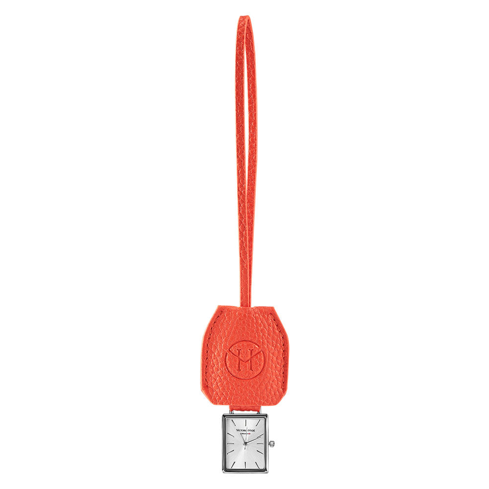 Victoria Hyde orange watch-shaped bag charm with chain. Minimalist design, subtle elegance, functional accessory. Pendant size 40x47 mm. Perfect for timeless style.