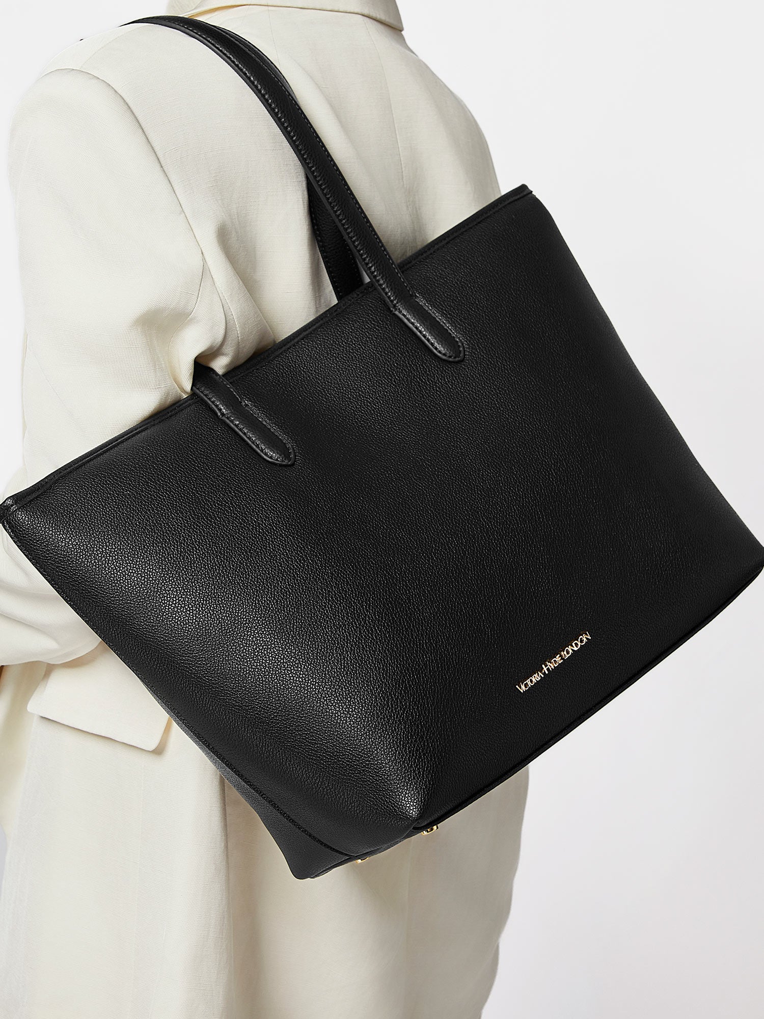 Black Yoana Large work bag by Victoria Hyde. Vegan microfiber leather, Shandong silk lining, padded 15" laptop compartment, removable cosmetic bag, water-repellent. Ideal for commuters.