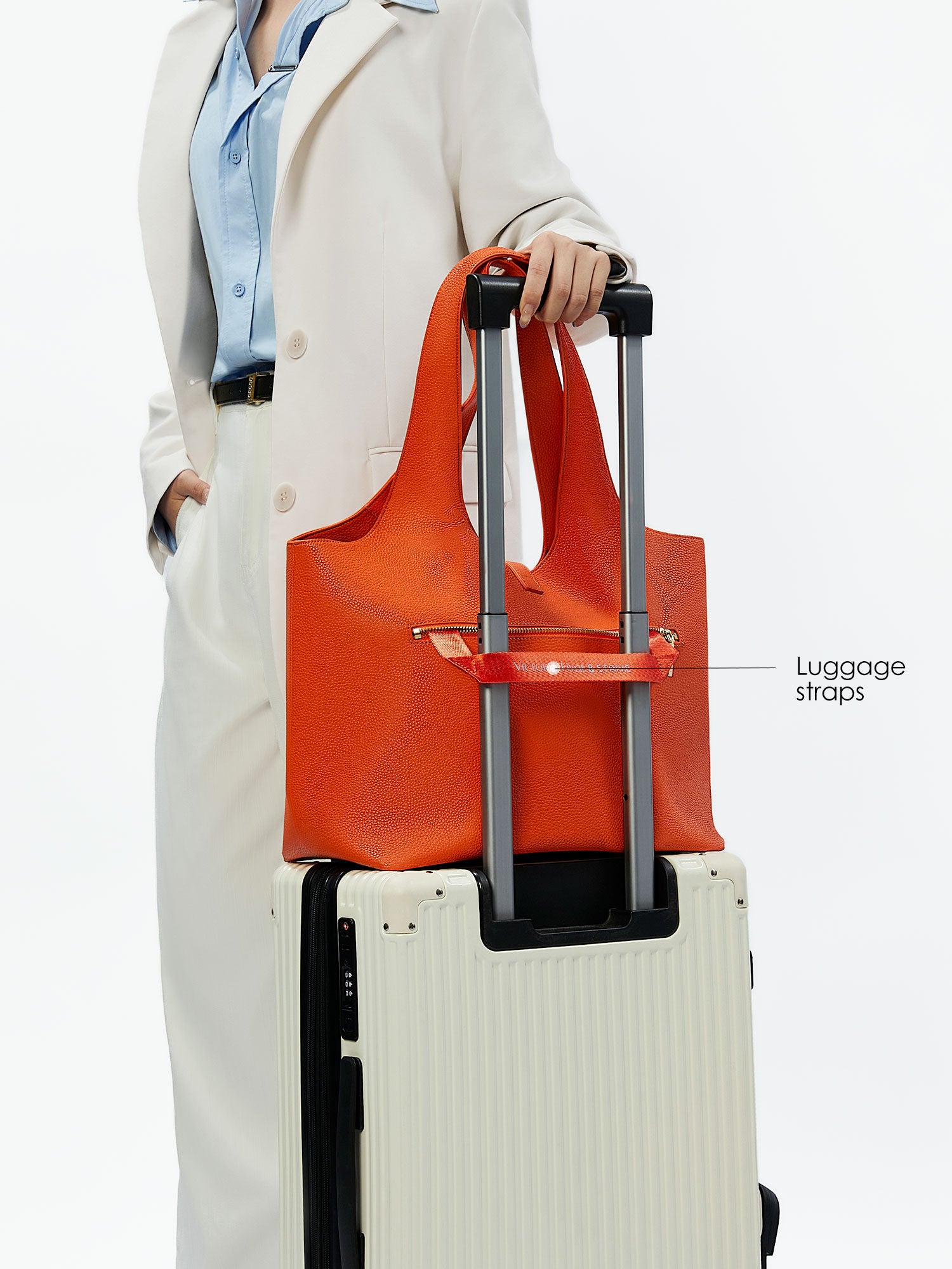 Victoria Hyde Strive Collection orange work bag with thoughtful interior pockets, removable laptop compartment, zippered back with trolley strap, durable microfiber leather, sustainable RPET lining, scratch-resistant & water-repellent. Ideal for professionals.