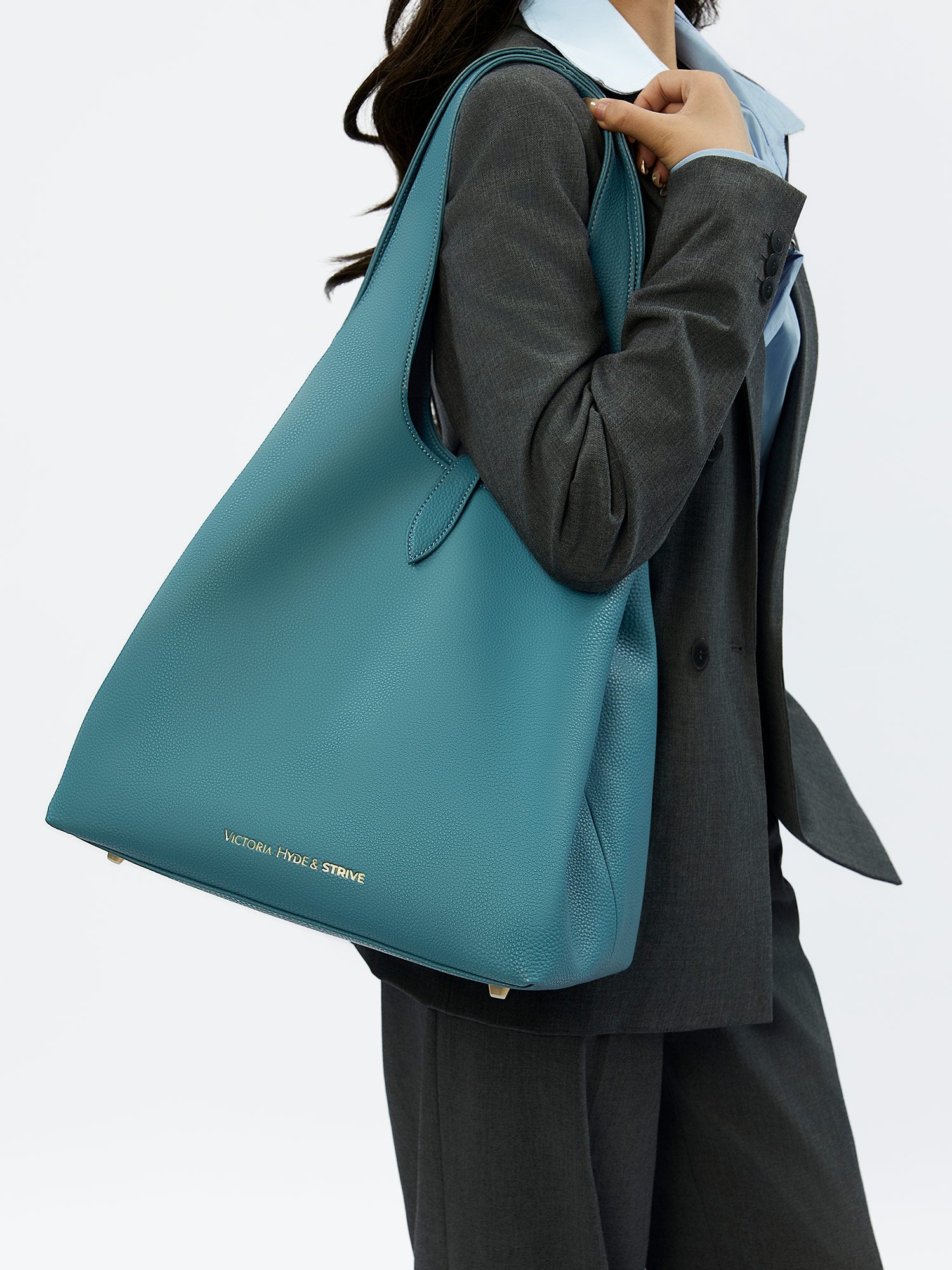 Victoria Hyde Strive Collection turquoise work bag. Microfiber leather, RPET lining. Interior pockets, removable laptop compartment, trolley strap. 0.85kg, 56x32x20 cm.