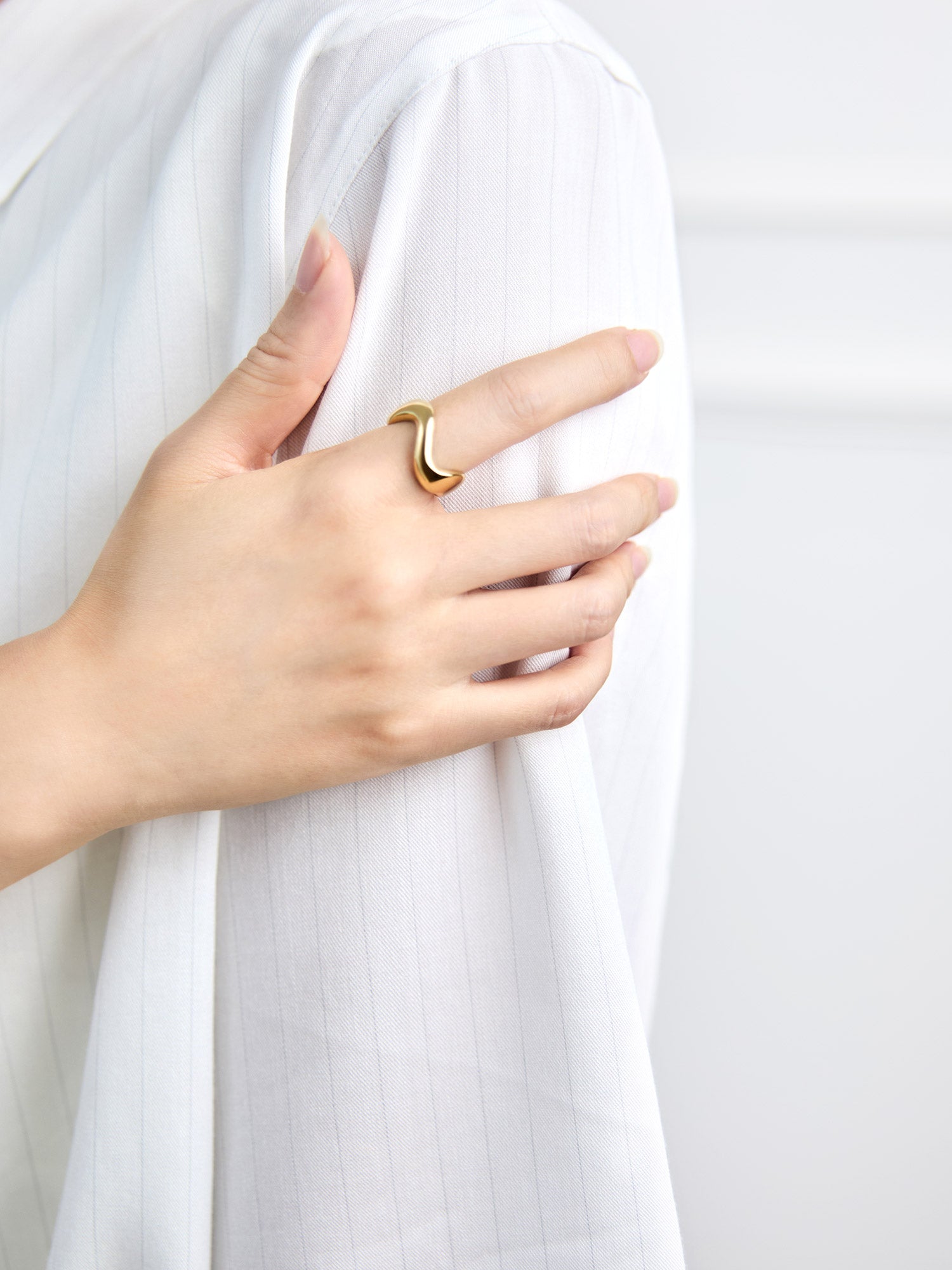 Victoria Hyde Ursula ring in 1N14 light gold, featuring an organic asymmetric design with variable width and a comfortable solid build made from eco-friendly copper for modern everyday styling