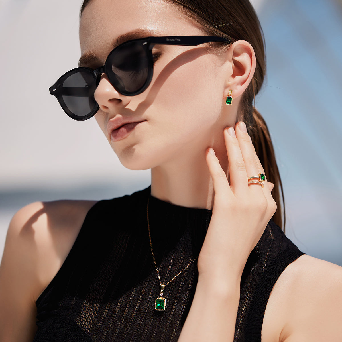 Victoria Hyde London jewelry set with light gold necklace and earrings, featuring deep green rectangular stones. Elegant, glamorous design for daily or special occasions.