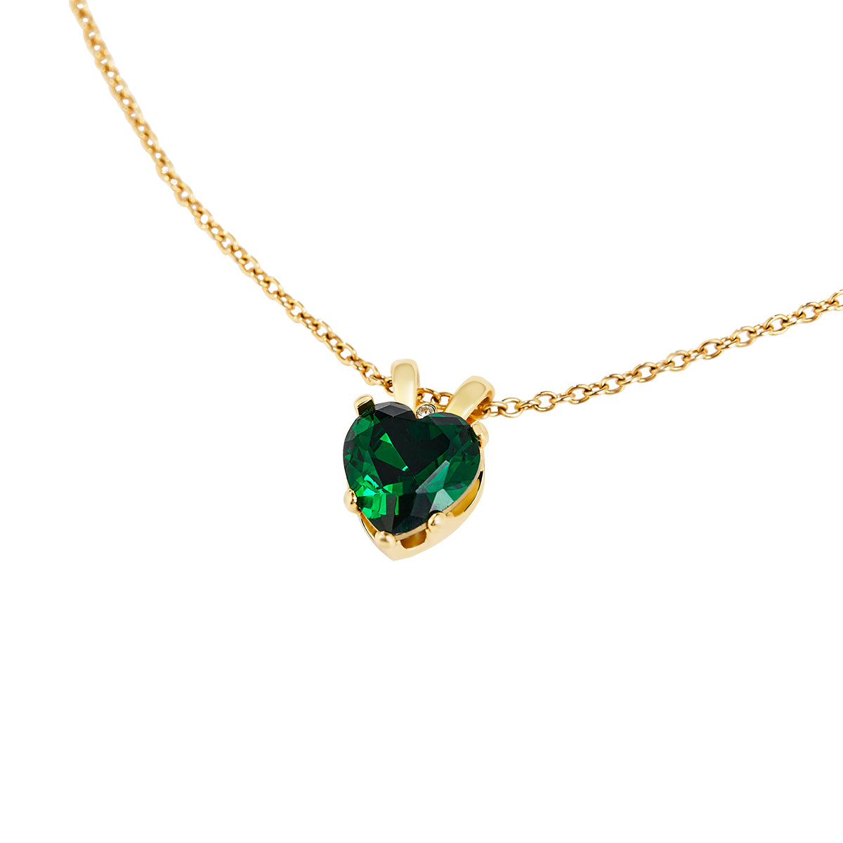 Victoria Hyde London heart-shaped jewelry set: necklace and earrings, light gold with deep green stones. Elegant, luxurious accessory for a refined look.