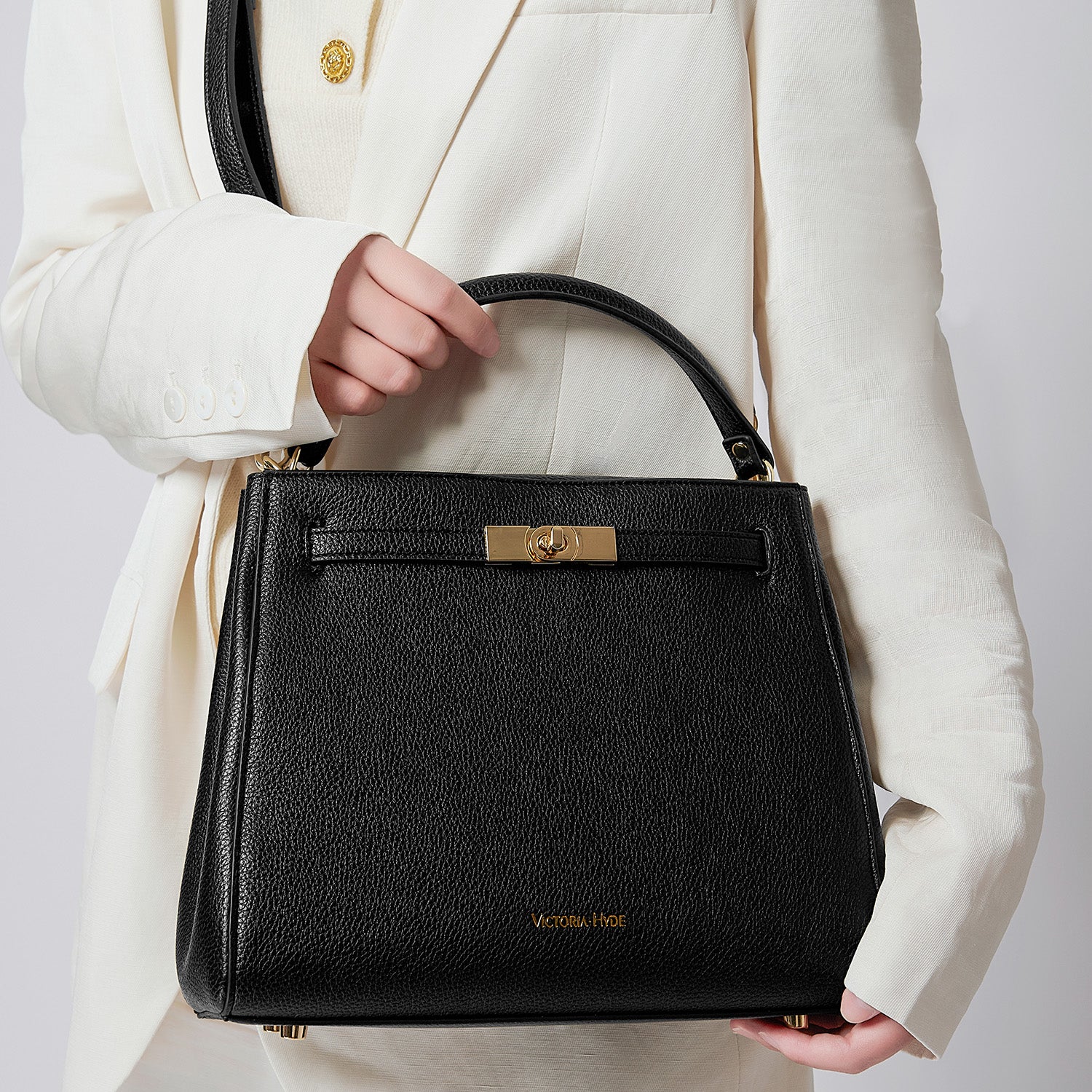 Victoria Hyde Victoria III work shoulder bag – trapezoid PU leather, gold closure, lightweight 0.7kg, fits 12.9" tablet, organizer pockets, 28x23x11 cm.