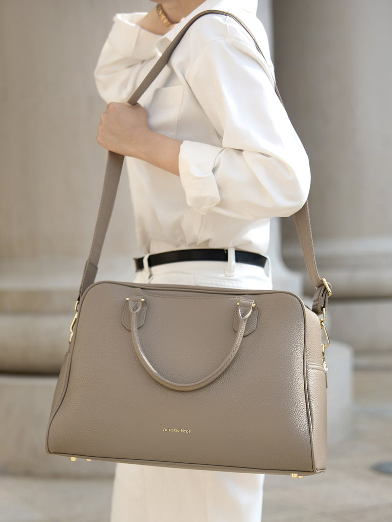 Interior mesh pocket of the Victoria Hyde Amal laptop bag, perfect for organizing charging cables, power adapters, and small tech accessories on the go.