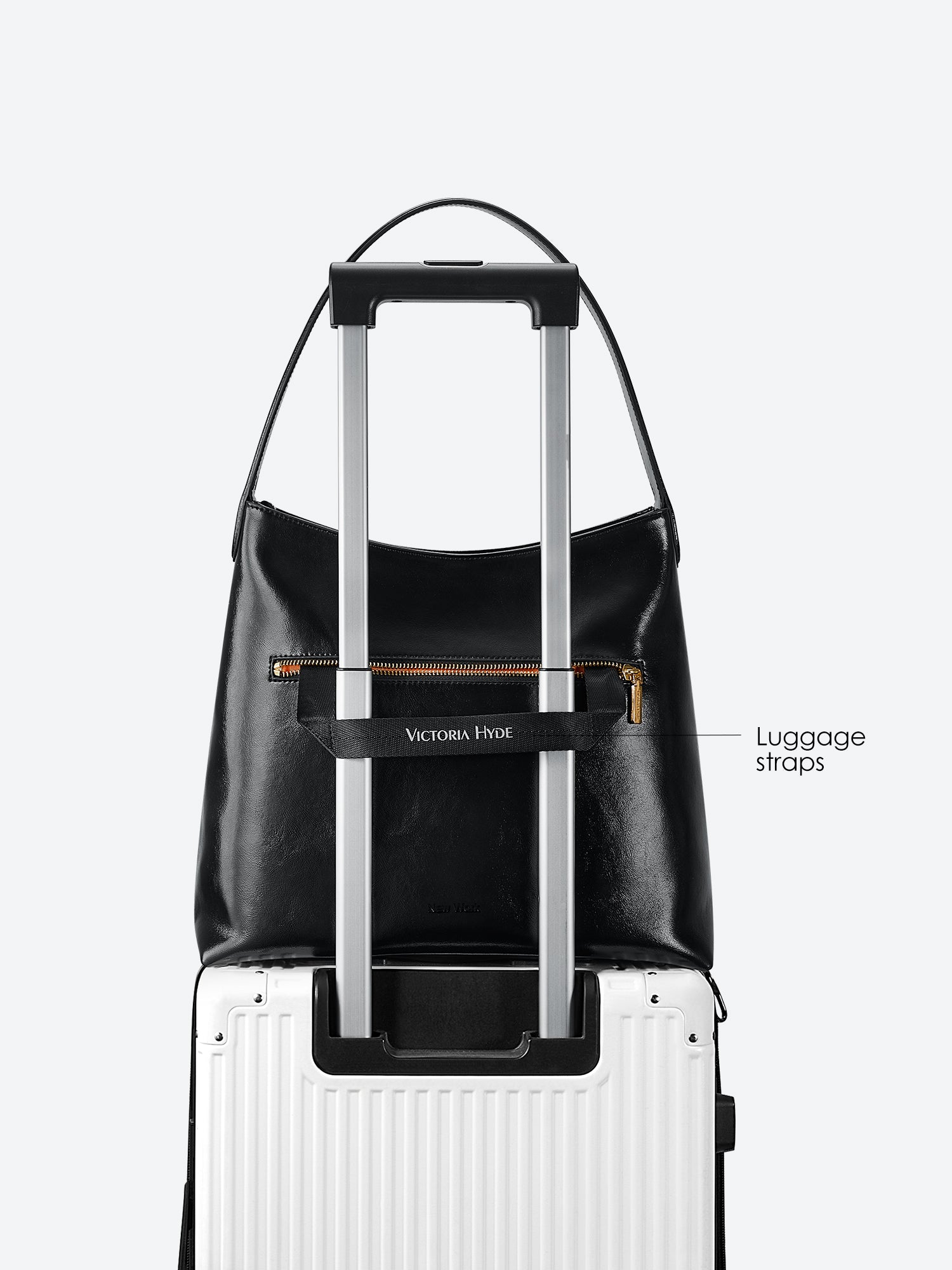 Victoria Hyde shoulder bag, microfiber leather, recycled lining. Padded sunglasses compartment, trolley strap, light gold hardware. “Love what you do” detail.