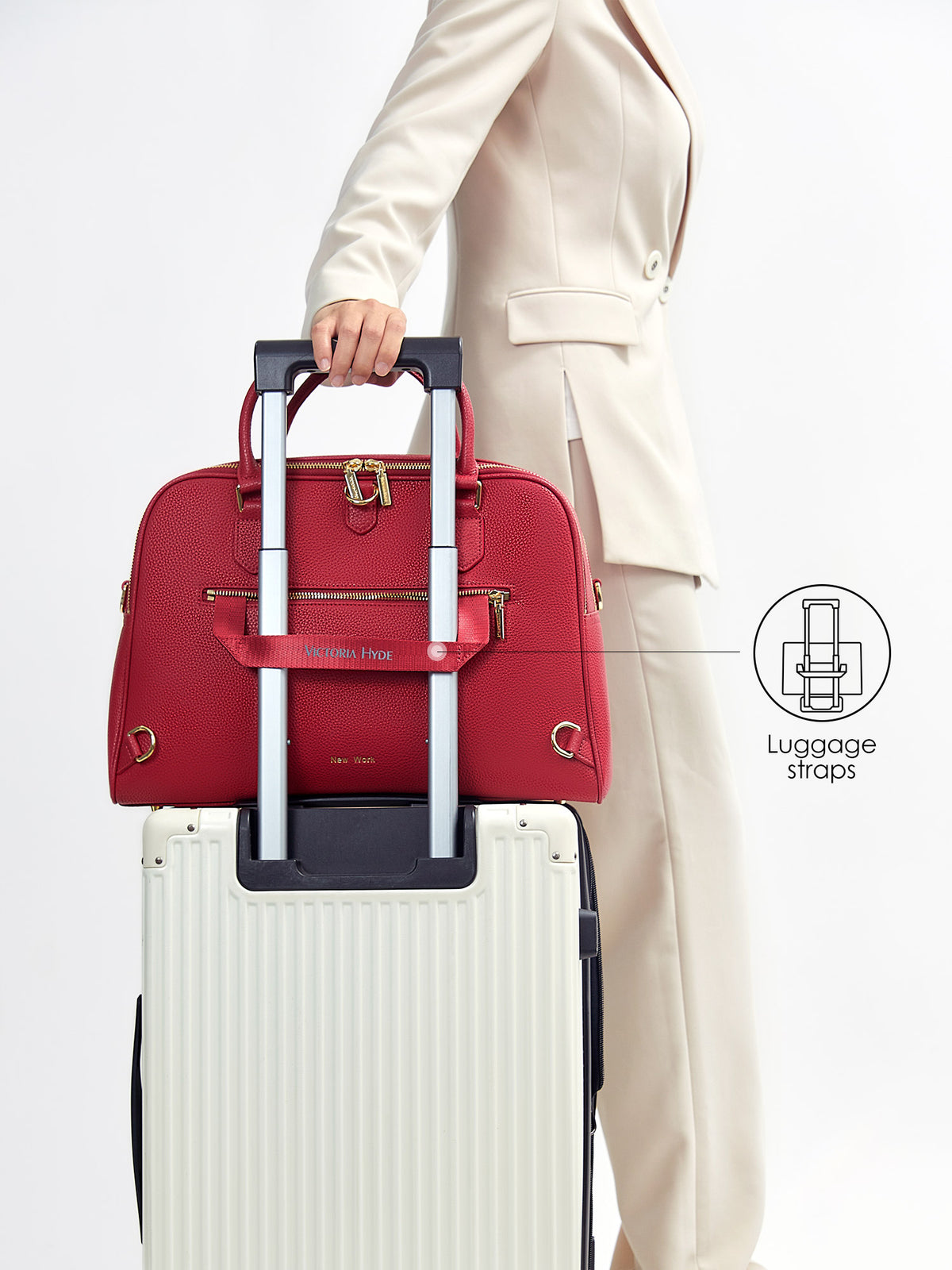 Victoria Hyde Amal garnet red business bag secured on suitcase handle with back luggage strap for travel