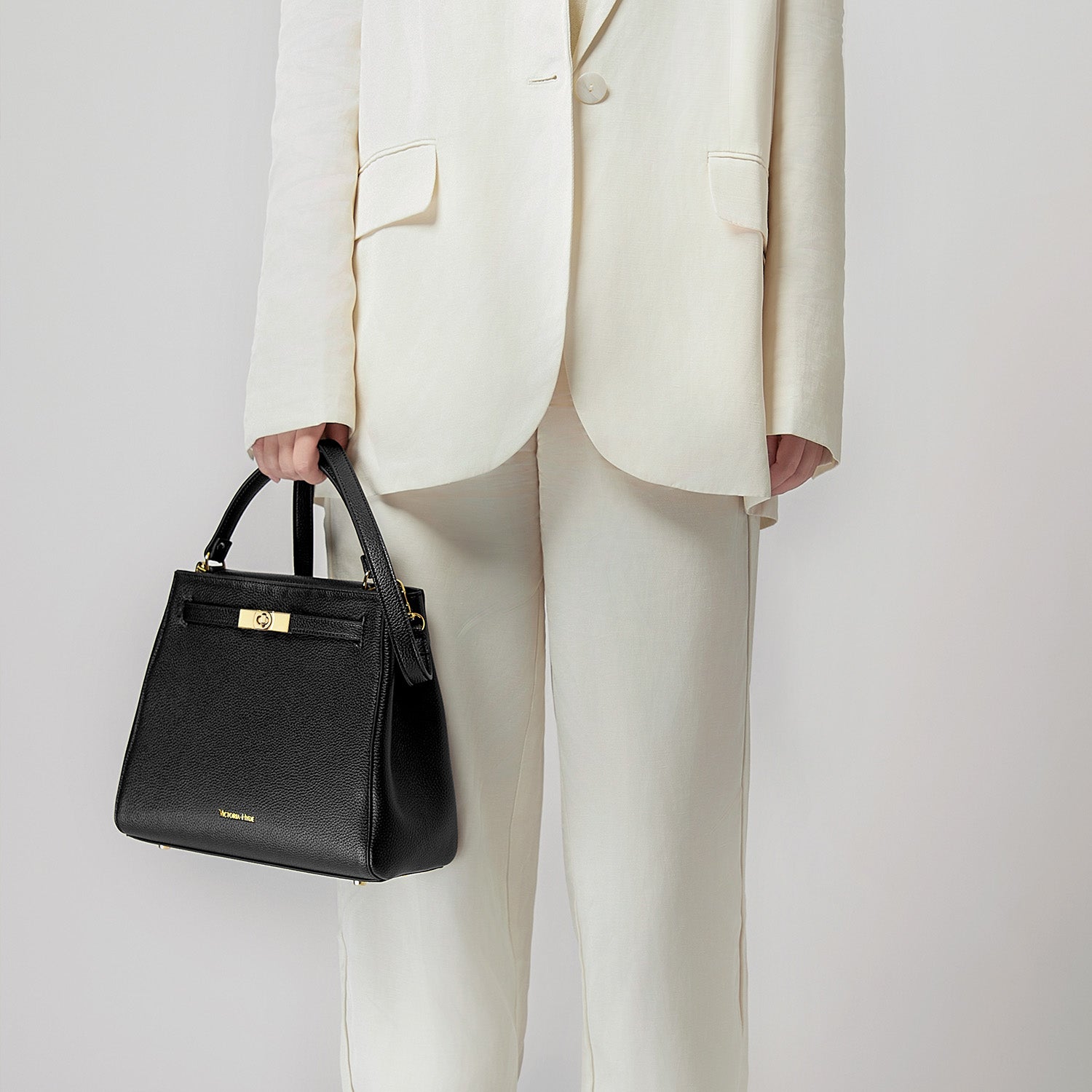 Victoria Hyde Victoria III work shoulder bag – trapezoid PU leather, gold closure, lightweight 0.7kg, fits 12.9" tablet, organizer pockets, 28x23x11 cm.